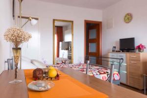 a dining room with a table and a bedroom at Studio in Vrbnik/Insel Krk 35988 in Vrbnik