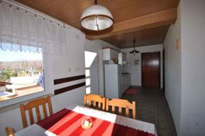 a kitchen and dining room with a table and chairs at Apartment in Risika/Island Krk 35824 in Risika