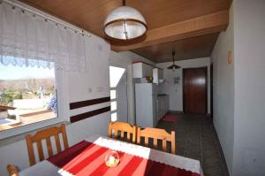 a kitchen and dining room with a table and chairs at Apartment in Risika - Island Krk 35824 in Risika