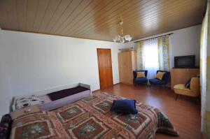 a bedroom with a large bed and a living room at Apartment in Risika - Island Krk 35824 in Risika