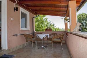 a patio with a table and chairs on a balcony at Apartment in Risika - Island Krk 35824 in Risika
