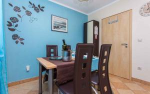 a dining room with a table and a blue wall at Apartment in Vrbnik/Insel Krk 35843 in Vrbnik