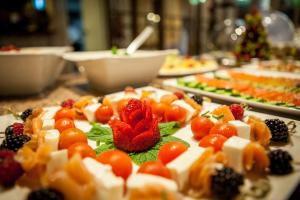 a table topped with plates of food with fruit at Charming Residence & Guest House Dom Manuel I Adults only in Lagos