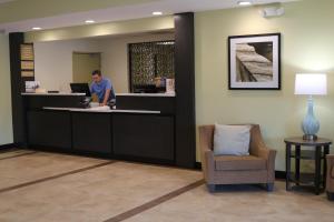 a man standing at a counter in a waiting room at Candlewood Suites Nashville - Goodlettsville by IHG in Goodlettsville +13 photos