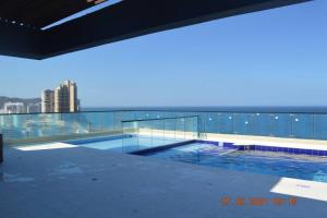 a swimming pool on the roof of a building at Apartasuite exclusivo VIP El Rodadero Santa Marta in Rodadero