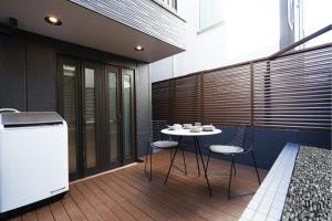 a patio with a table and chairs on a balcony at Real Life SANGENJAYA in Tokyo