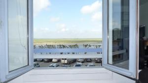 an open window with a view of a parking lot at Violette avec parking privé sécurisé in Saint-Valery-sur-Somme