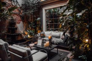 a living room with a couch and a window at CASA EMILIA B&B Boutique in Mexico City