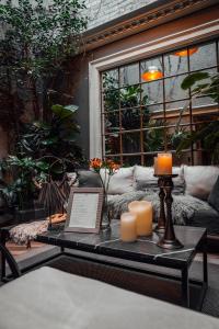 a coffee table with candles and a laptop on it at CASA EMILIA B&B Boutique in Mexico City