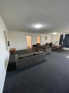 a living room filled with furniture and a large window at Parkside Inn Motel in Melbourne