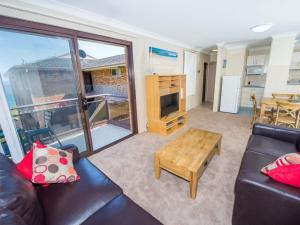 a living room with a couch and a table at Collendina 15 19 Kurrawa Close water views and wifi in Nelson Bay