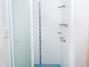 a bathroom with a shower with a glass door at Collendina 15 19 Kurrawa Close water views and wifi in Nelson Bay