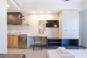 a kitchen with a table and a chair in a room at MEDITERRANEO in Skala Potamias