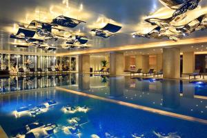 a large swimming pool in a hotel lobby at InterContinental Kunming by IHG in Kunming