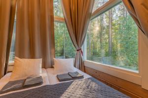 a bedroom with a bed and a large window at Saimaa Life Apartments in Imatra +141 photos