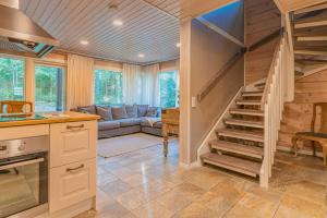 a kitchen and living room with a spiral staircase at Saimaa Life Apartments in Imatra