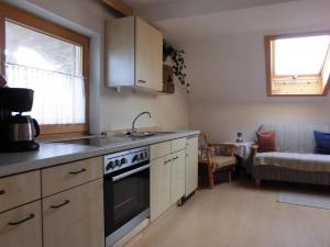 a kitchen with a sink and a stove top oven at Haus Wegscheider in Teisendorf