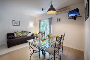 a living room with a glass table and chairs at Apartments Zambarlin in Komiža