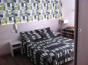 A bed or beds in a room at Hotel Ave