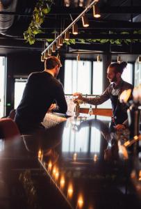 two men sitting at a table in a barber shop at Lily Country Club in Klofta