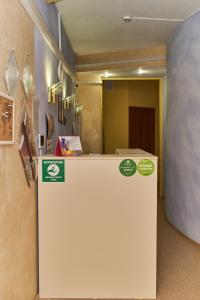 a white refrigerator with green stickers on it in a room at Like хостел Саратов in Saratov