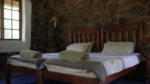 a bed with two pillows on it in a bedroom at Griffons Bush Camp in Thabazimbi