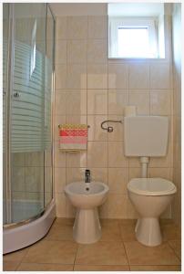 a bathroom with a toilet and a shower and a sink at Apartment in Slatine with sea view, balcony, air conditioning, Wi-Fi (4782-1) in Slatine