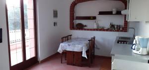 a kitchen with a table with chairs and a counter top at CASA OLEANDRO in Finale Ligure