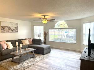 a living room with a couch and a table at Grand Family 3BD Condo Apartment near Disney Parks #5 in Kissimmee