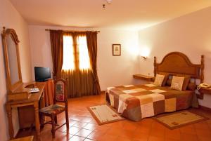 En eller flere senger på et rom på Hotel Quinta Da Lagoa