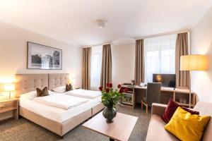 Rúm í herbergi á Altstadthotel Wolf-Dietrich