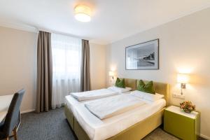 Rúm í herbergi á Altstadthotel Wolf-Dietrich