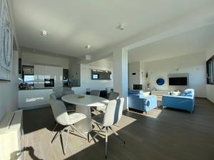 a dining room and living room with a table and chairs at The View Luxury Residence with Pool in Zadar