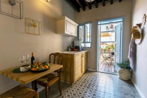 a kitchen with a table with a bowl of fruit on it at Saint Anna Acre in Acre