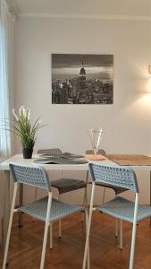 a dining room table with two chairs and a picture on the wall at Apartament Wiosenny 52m2 Kłodzko in Kłodzko