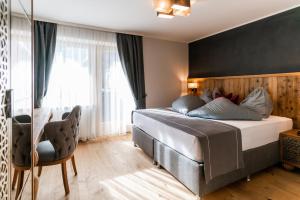 A bed or beds in a room at Waidringer Hof 4 Sterne Superior