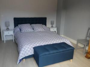 a bedroom with a blue bed and two night stands at BEL APPARTEMENT TYPE F3 in Amélie-les-Bains-Palalda