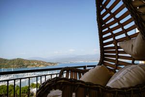 a wicker chair with a view of the ocean at El Camino Hostel & Pub in Fethiye