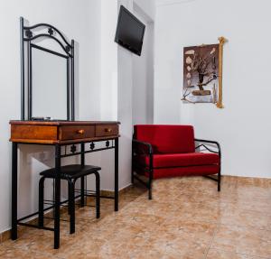 a room with a desk and a red chair at Villa Toula in Fira