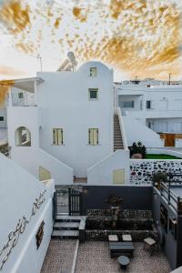 a view from the balcony of a white building with stairs at Villa Toula in Fira