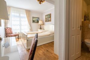 a hotel room with a bed and a chair at Romantisches Hotel zur Post in Brodenbach +72 photos