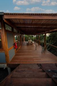 a wooden deck with a bench on it at Aloha 22 in Ponta Mamoli
