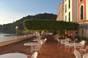 a row of tables and chairs on a balcony at Hotel Lido Mediterranee in Taormina