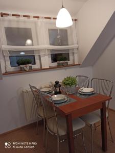 a dining room with a wooden table and chairs at Pokoje Gościnne Izabela in Szklarska Poręba