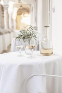 zwei Weingläser und eine Vase auf dem Tisch in der Unterkunft Apartments 1620yr Trnava in Trnava