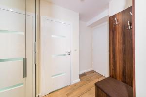 a room with a closet with white walls and wooden floors at Deluxe Apartment Rakowicka 15 WAWELOFTS in Krakow