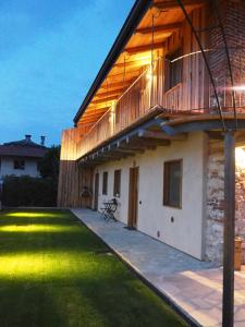 ein Haus mit Balkon und Rasenhof in der Unterkunft Virasol in Dronero