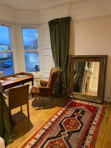 a living room with a mirror and a table at The Fig Tree Hotel Markinch in Markinch