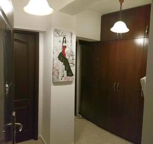 a bathroom with a black door and a painting on the wall at Sudului 810 by MRG Apartments - Spitalul Bagdasar - Spitalul Obregia in Bucharest