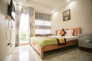 a bedroom with a bed and a television in it at Ngoc Trai 02 FLC Sam Son in Sầm Sơn +64 photos